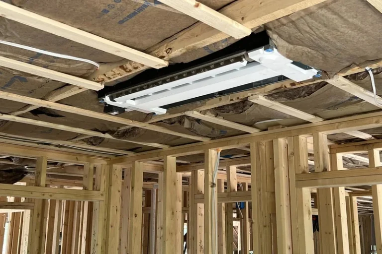 # Alt Text
Unfinished residential room with wooden framing, ceiling joists, and mounted HVAC ductwork installation